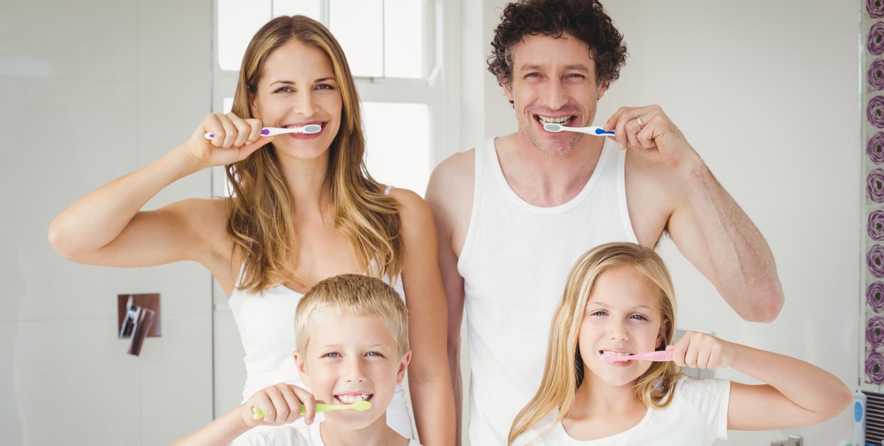 Portrait of smiling family brushing teeth
